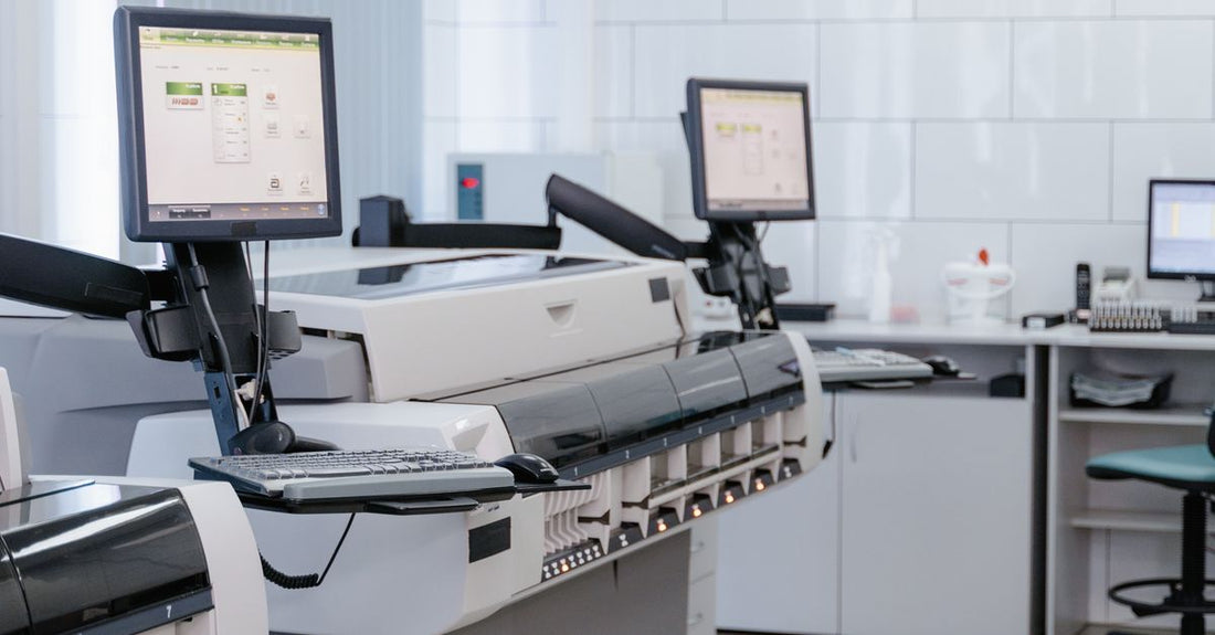 Medical imaging printer and workstation equipment in a clinical laboratory setting, representing the Sony UP-D898MD and UP-X898MD ultrasound printer maintenance environment