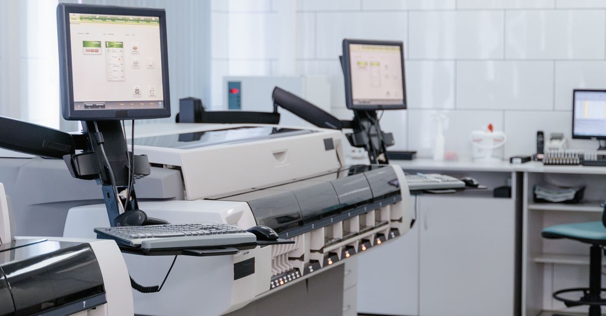 Medical imaging printer and workstation equipment in a clinical laboratory setting, representing the Sony UP-D898MD and UP-X898MD ultrasound printer maintenance environment
