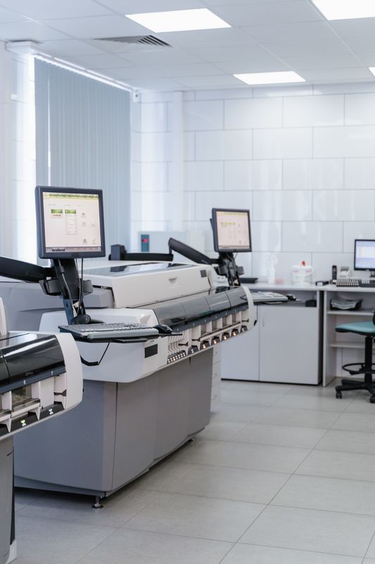 Medical printer and imaging equipment in a clinical lab setting, illustrating printer menu and paper settings for ultrasound thermal printers